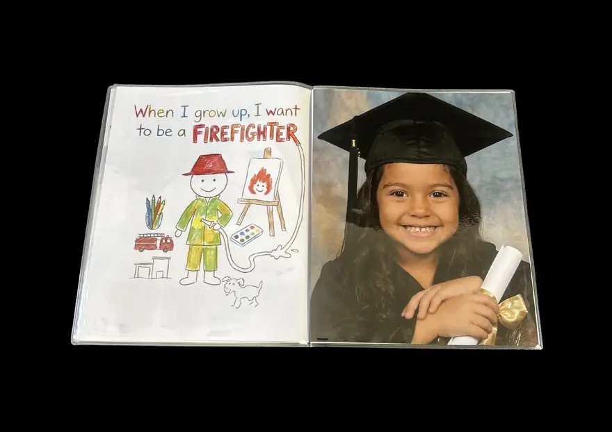 Open book spread showing the child's 'when I grow up' drawing opposite another 25 by 20 centimetre portrait